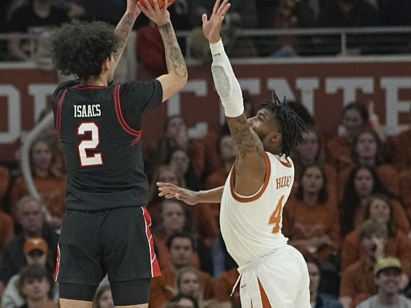 Jan 6, 2024; Austin, Texas, USA; Texas Tech Red Raiders guard Pop Isaacs (2) shoots over Texas Longhorns guard Tyrese Hunter (4) during the first half at Moody Center. Mandatory Credit: Scott Wachter-USA TODAY Sports