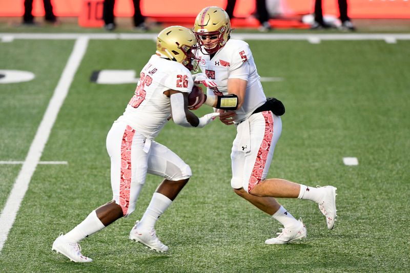 Nov 14, 2020; Chestnut Hill, Massachusetts, USA; Boston College Eagles quarterback Phil Jurkovec (5) hands the ball off to running back David Bailey (26) during the the first half against the Notre Dame Fighting Irish at Alumni Stadium. Mandatory Credit: Brian Fluharty-USA TODAY Sports