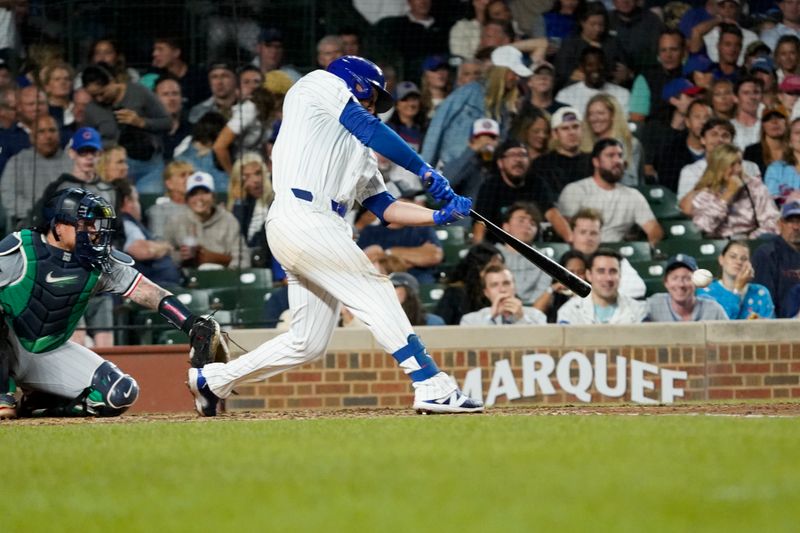 Aug 6, 2024; Chicago, Illinois, USA; Chicago Cubs first baseman Michael Busch (29) hits a single against the Minnesota Twins during the fifth inning at Wrigley Field. Mandatory Credit: David Banks-USA TODAY Sports