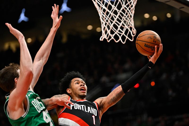 PORTLAND, OREGON - MARCH 17: Anfernee Simons #1 of the Portland Trail Blazers drives to the basket against Luke Kornet #40 of the Boston Celtics during the second quarter at the Moda Center on March 17, 2023 in Portland, Oregon. NOTE TO USER: User expressly acknowledges and agrees that, by downloading and or using this photograph, User is consenting to the terms and conditions of the Getty Images License Agreement. (Photo by Alika Jenner/Getty Images)