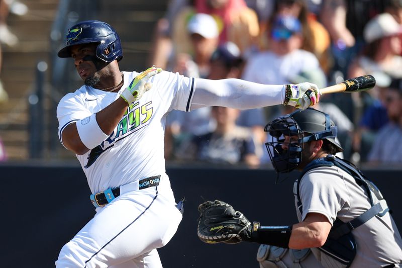 Apr 19, 2025; Tampa, Florida, USA;  Tampa Bay Rays designated hitter Yandy Diaz (2) hits a base hit against the New York Yankees in the third inning at George M. Steinbrenner Field. Mandatory Credit: Nathan Ray Seebeck-Imagn Images