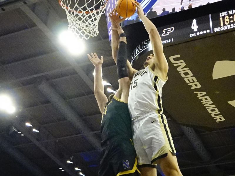 Dec 1, 2023; Evanston, Illinois, USA; Northwestern Wildcats center Matthew Nicholson (34) defends Purdue Boilermakers center Zach Edey (15) during the first half at Welsh-Ryan Arena. Mandatory Credit: David Banks-USA TODAY Sports