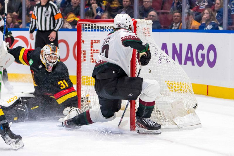 Apr 10, 2024; Vancouver, British Columbia, CAN; Arizona Coyotes forward Logan Cooley (92) scores the game winning goal in overtime on Vancouver Canucks goalie Arturs Silvos (31) at Rogers Arena. Arizona won 4-3 in overtime. Mandatory Credit: Bob Frid-USA TODAY Sports