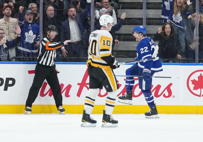 Apr 8, 2024; Toronto, Ontario, CAN; Toronto Maple Leafs defenseman Jake McCabe (22) scores the winning goal and celebrates against the Pittsburgh Penguins during the overtime period at Scotiabank Arena. Mandatory Credit: Nick Turchiaro-USA TODAY Sports