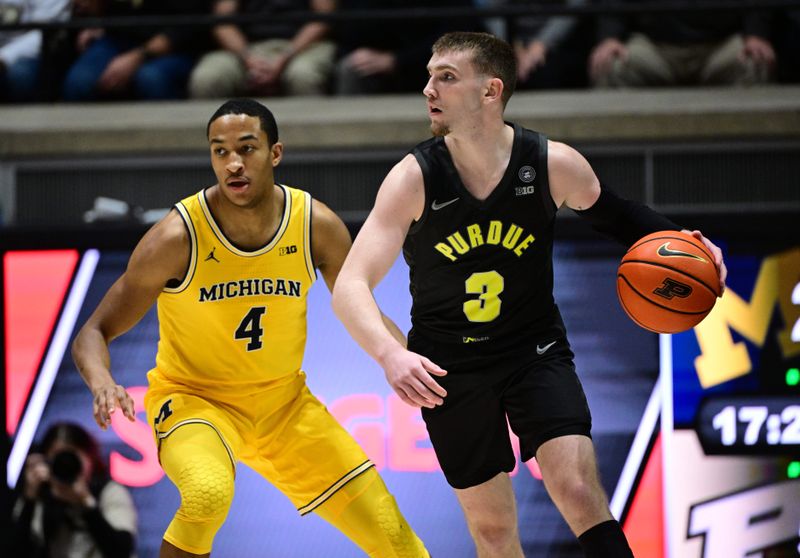 Jan 23, 2024; West Lafayette, Indiana, USA; Purdue Boilermakers guard Braden Smith (3) dribbles the ball away from Michigan Wolverines guard Nimari Burnett (4) during the first half at Mackey Arena. Mandatory Credit: Marc Lebryk-USA TODAY Sports