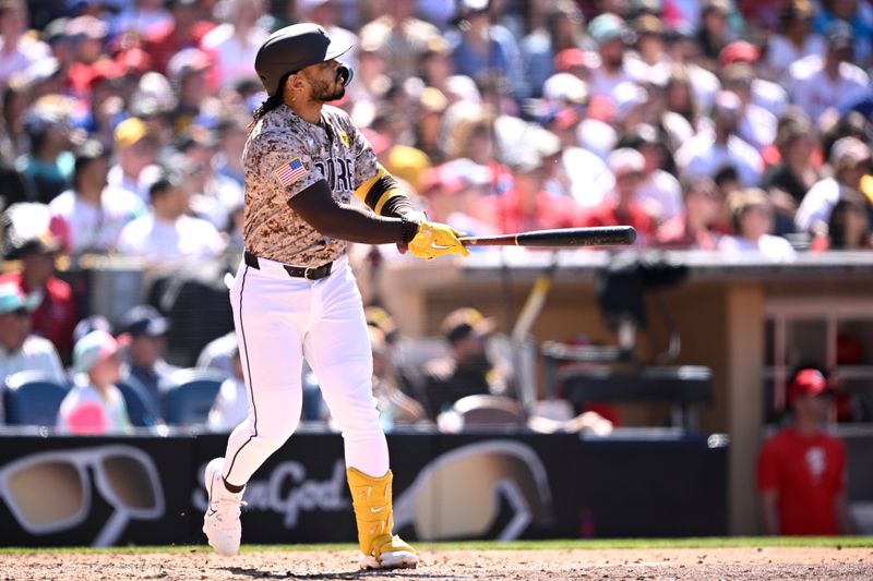 Apr 28, 2024; San Diego, California, USA; San Diego Padres catcher Luis Campusano (12) hits a three-run home run against the Philadelphia Phillies during the seventh inning at Petco Park. Mandatory Credit: Orlando Ramirez-USA TODAY Sports