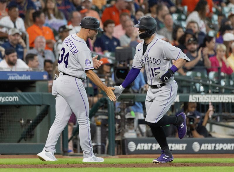 Jul 5, 2023; Houston, Texas, USA; Colorado Rockies center fielder Randal Grichuk (15) celebrates with third base coach Warren Schaeffer (34) after hitting a home run against the Houston Astros in the seventh inning at Minute Maid Park. Mandatory Credit: Thomas Shea-USA TODAY Sports