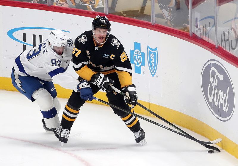 Nov 19, 2024; Pittsburgh, Pennsylvania, USA; Pittsburgh Penguins center Sidney Crosby (87) skates with the puck against Tampa Bay Lightning center Gage Goncalves (93) during the second period at PPG Paints Arena. Mandatory Credit: Charles LeClaire-Imagn Images