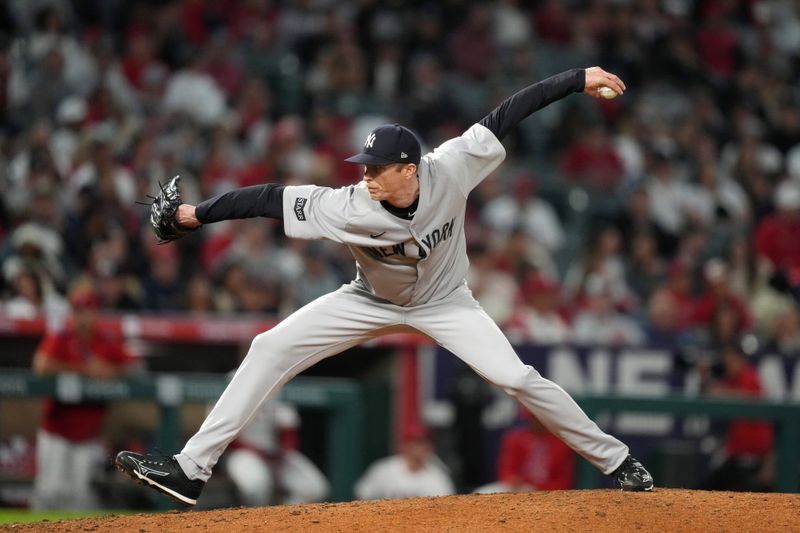 May 28, 2025; Anaheim, California, USA;  New York Yankees relief pitcher Tim Hill (41) throws in the eighth inning against the Los Angeles Angels at Angel Stadium. Mandatory Credit: Kirby Lee-Imagn Images