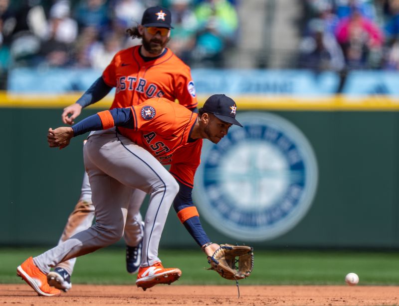 Apr 9, 2025; Seattle, Washington, USA;  Houston Astros shortstop Jeremy Pena (3) fields a ground ball during the third inning against the Seattle Mariners at T-Mobile Park. Mandatory Credit: Stephen Brashear-Imagn Images