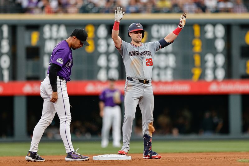 Jun 21, 2024; Denver, Colorado, USA; Washington Nationals right fielder Lane Thomas (28) reacts from second ahead of Colorado Rockies second baseman Alan Trejo (13) after hitting a two RBI double in the fourth inning at Coors Field. Mandatory Credit: Isaiah J. Downing-USA TODAY Sports