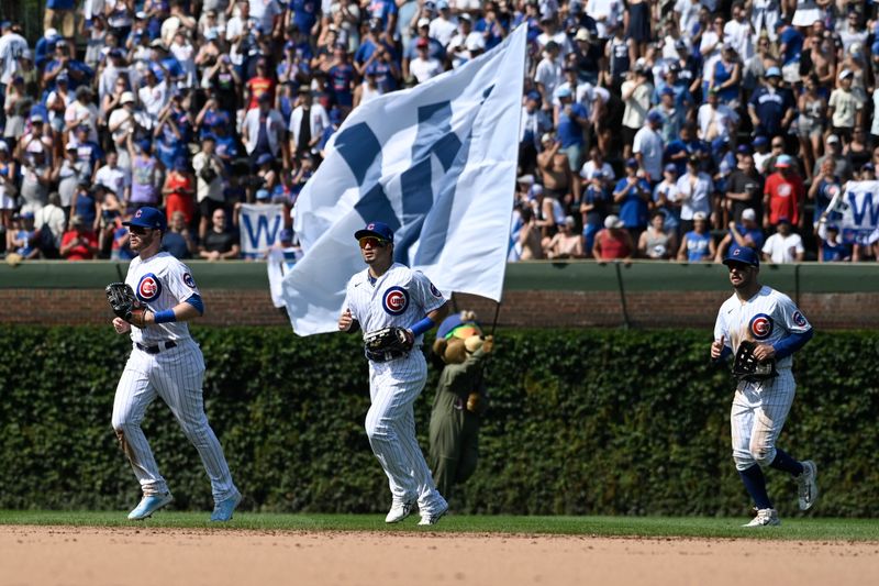 Aug 20, 2023; Chicago, Illinois, USA;  Chicago Cubs left fielder Ian Happ (8), Chicago Cubs right fielder Seiya Suzuki (27) and Chicago Cubs center fielder Mike Tauchman (40) after the game against the Kansas City Royals at Wrigley Field. Mandatory Credit: Matt Marton-USA TODAY Sports