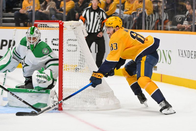 Oct 26, 2025; Nashville, Tennessee, USA;  Dallas Stars goaltender Casey Desmith (1) blocks the shot of Nashville Predators defenseman Adam Wilsby (83) during the first period at Bridgestone Arena. Mandatory Credit: Steve Roberts-Imagn Images