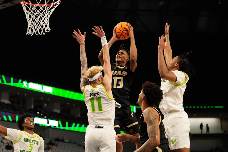 Mar 16, 2024; Fort Worth, TX, USA;  UAB Blazers forward Christian Coleman (13) scores a basket against South Florida Bulls forward Kasean Pryor (11) during the second half at Dickies Arena. Mandatory Credit: Chris Jones-USA TODAY Sports