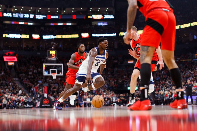 TORONTO, CANADA - OCTOBER 25: Anthony Edwards #5 of the Minnesota Timberwolves dribbles the ball to the net against Jakob Poeltl #19 of the Toronto Raptors during the first half of their NBA game at Scotiabank Arena on October 25, 2023 in Toronto, Canada. NOTE TO USER: User expressly acknowledges and agrees that, by downloading and or using this photograph, User is consenting to the terms and conditions of the Getty Images License Agreement. (Photo by Cole Burston/Getty Images)