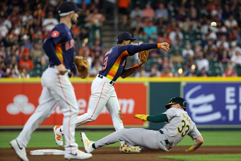 May 15, 2024; Houston, Texas, USA; Houston Astros shortstop Jeremy Peña (3) turns a double play on Oakland Athletics outfielder JJ Bleday (33) in the eighth inning at Minute Maid Park. Mandatory Credit: Thomas Shea-USA TODAY Sports