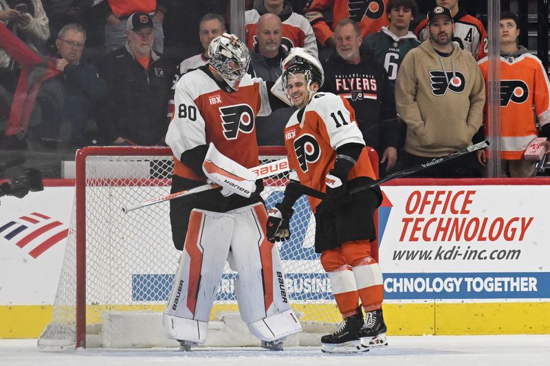 Dec 9, 2025; Philadelphia, Pennsylvania, USA; Philadelphia Flyers goaltender Dan Vladar (80) and right wing Travis Konecny (11) celebrate win against the San Jose Sharks at Xfinity Mobile Arena. Mandatory Credit: Eric Hartline-Imagn Images