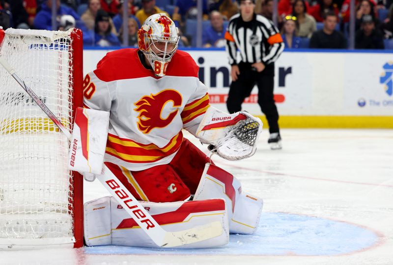 Nov 9, 2024; Buffalo, New York, USA;  Calgary Flames goaltender Dan Vladar (80) looks for the puck during the second period against the Buffalo Sabres at KeyBank Center. Mandatory Credit: Timothy T. Ludwig-Imagn Images