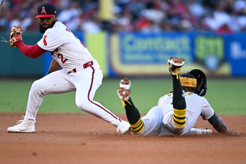 Jul 27, 2024; Anaheim, California, USA; Oakland Athletics outfielder Lawrence Butler (4) steals second base against Los Angeles Angels second baseman Luis Rengifo (2) during the first inning at Angel Stadium. Mandatory Credit: Jonathan Hui-USA TODAY Sports