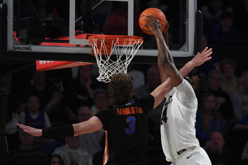 Mar 9, 2024; Nashville, Tennessee, USA; Vanderbilt Commodores forward JaQualon Roberts (24) dunks the ball against Florida Gators center Micah Handlogten (3) during the second half at Memorial Gymnasium. Mandatory Credit: Christopher Hanewinckel-USA TODAY Sports