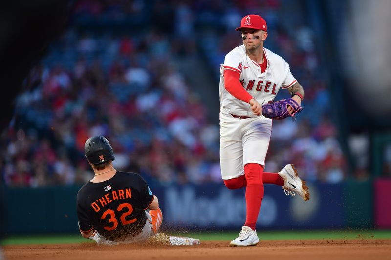 May 10, 2025; Anaheim, California, USA; Baltimore Orioles right fielder Ryan O'Hearn (32) is out at second as Los Angeles Angels shortstop Zach Neto (9) throws to first for the out against center fielder Cedric Mullins (31) during the fourth inning at Angel Stadium. Mandatory Credit: Gary A. Vasquez-Imagn Images