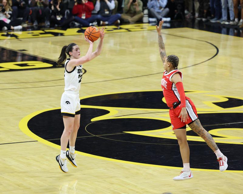 Mar 3, 2024; Iowa City, Iowa, USA; Iowa Hawkeyes guard Caitlin Clark (22) shoots over Ohio State Buckeyes guard Rikki Harris (1) during the first half at Carver-Hawkeye Arena. Mandatory Credit: Reese Strickland-USA TODAY Sports