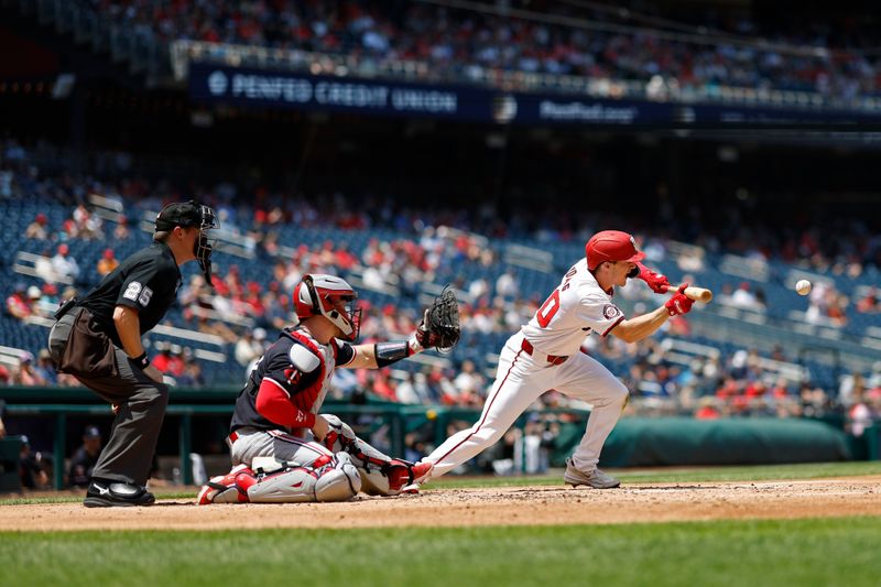 May 22, 2024; Washington, District of Columbia, USA; Washington Nationals outfielder Jacob Young (30) hits a sacrifice bunt against the Minnesota Twins during the third inning at Nationals Park. Mandatory Credit: Geoff Burke-USA TODAY Sports