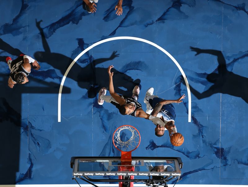 MINNEAPOLIS, MN -  FEBRUARY 27: Monte Morris #23 of the Minnesota Timberwolves shoots the ball while Victor Wembanyama #1 of the San Antonio Spurs goes up for the block during the game on February 27, 2024 at Target Center in Minneapolis, Minnesota. NOTE TO USER: User expressly acknowledges and agrees that, by downloading and or using this Photograph, user is consenting to the terms and conditions of the Getty Images License Agreement. Mandatory Copyright Notice: Copyright 2024 NBAE (Photo by David Sherman/NBAE via Getty Images)