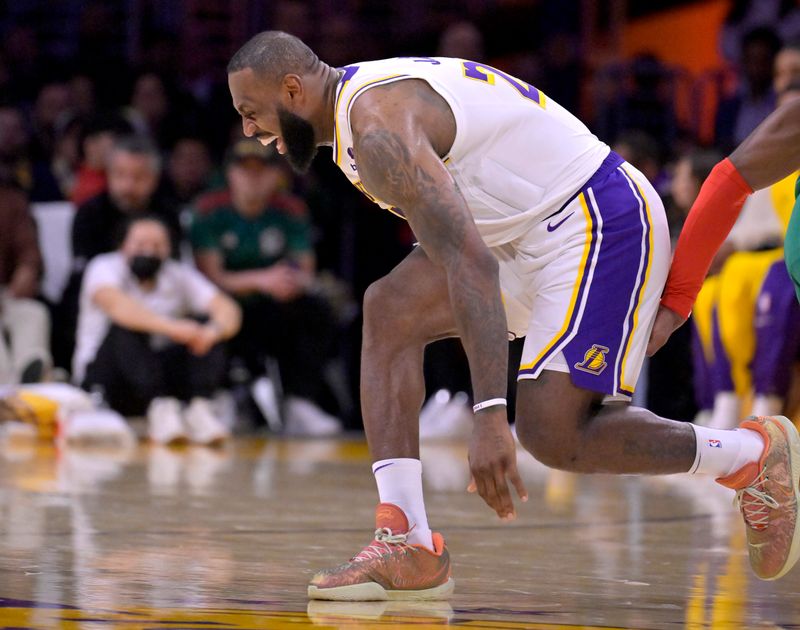 LOS ANGELES, CALIFORNIA - DECEMBER 25: LeBron James #23 of the Los Angeles Lakers grimaces in pain after a collision with Jaylen Brown #7 of the Boston Celtics in the first half at Crypto.com Arena on December 25, 2023 in Los Angeles, California. NOTE TO USER: User expressly acknowledges and agrees that, by downloading and or using this photograph, User is consenting to the terms and conditions of the Getty Images License Agreement.(Photo by Jayne Kamin-Oncea/Getty Images)