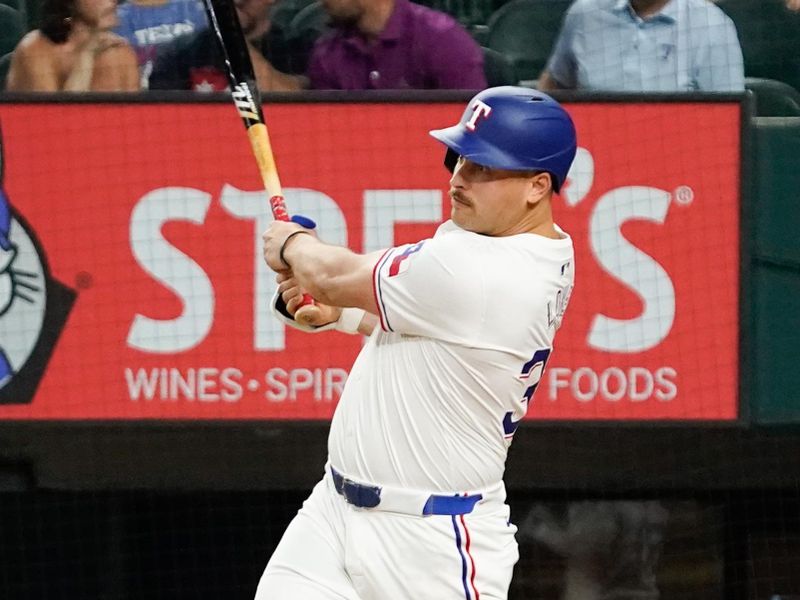 May 18, 2024; Arlington, Texas, USA; Texas Rangers first baseman Nathaniel Lowe (30) hits an RBI sacrifice fly during the eighth inning against the Los Angeles Angels at Globe Life Field. Mandatory Credit: Raymond Carlin III-USA TODAY Sports