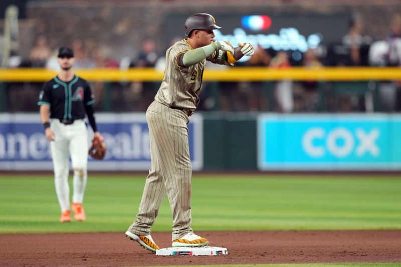 May 4, 2024; Phoenix, Arizona, USA; San Diego Padres third base Manny Machado (13) celebrates after an RBI double against the Arizona Diamondbacks during the seventh inning at Chase Field. Mandatory Credit: Joe Camporeale-USA TODAY Sports