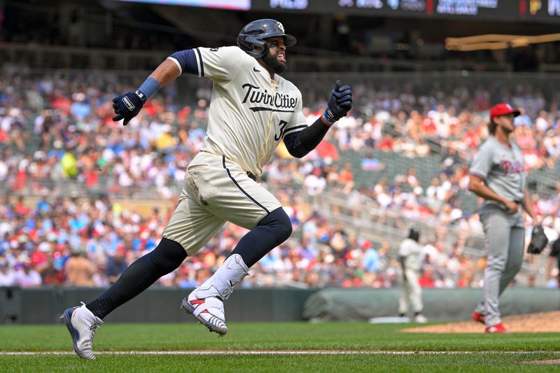 Jul 24, 2024; Minneapolis, Minnesota, USA;  Minnesota Twins infielder Carlos Santana (30) rounds first base after hitting a double against the Philadelphia Phillies during the sixth inning at Target Field. Mandatory Credit: Nick Wosika-USA TODAY Sports