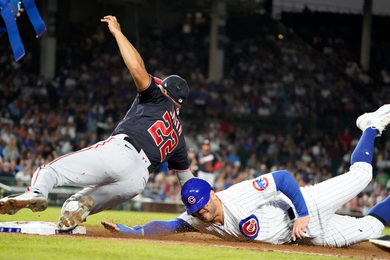 Jul 18, 2023; Chicago, Illinois, USA; Chicago Cubs center fielder Mike Tauchman (40) slides safely into first base as Washington Nationals first baseman Dominic Smith (22) tries to make a tag during the sixth inning at Wrigley Field. Mandatory Credit: David Banks-USA TODAY Sports