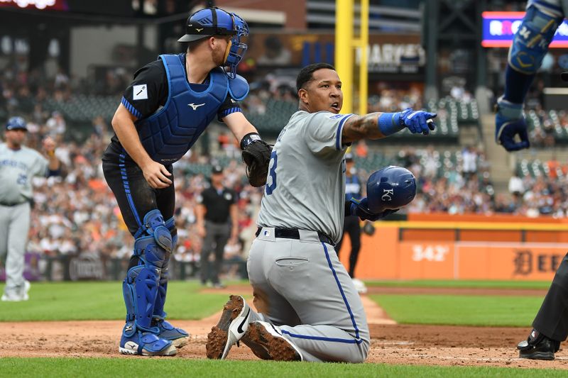 Aug 2, 2024; Detroit, Michigan, USA;  Kansas City Royals first baseman Salvador Perez (13) points to the dugout for a review after he was initially called out sliding into home plate under the tag of Detroit Tigers catcher Jake Rogers (34) in the fourth inning at Comerica Park. The play was reviewed and Perez was called safe. Mandatory Credit: Lon Horwedel-USA TODAY Sports