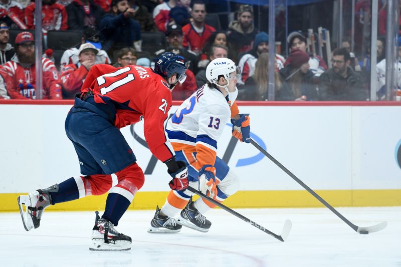 Feb 2, 2026; Washington, District of Columbia, USA; New York Islanders center Mathew Barzal (13) controls the puck defended by Washington Capitals center Aliaksei Protas (21) during the first period at Capital One Arena. Mandatory Credit: Hannah Foslien-Imagn Images