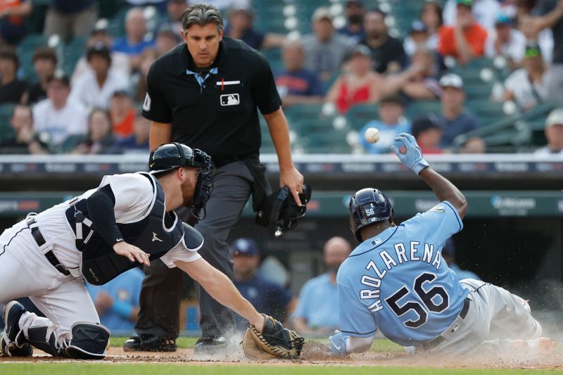 Aug 4, 2023; Detroit, Michigan, USA;  Tampa Bay Rays left fielder Randy Arozarena (56) slides in safe at home ahead of the tag by Detroit Tigers catcher Jake Rogers (34) in the first inning at Comerica Park. Mandatory Credit: Rick Osentoski-USA TODAY Sports