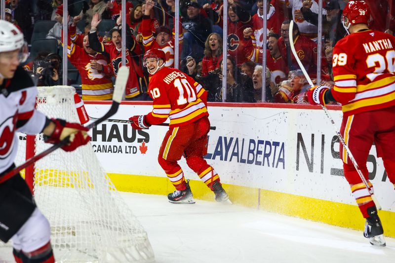 Nov 1, 2024; Calgary, Alberta, CAN; Calgary Flames center Jonathan Huberdeau (10) celebrates his goal with teammates against the New Jersey Devils during the third period at Scotiabank Saddledome. Mandatory Credit: Sergei Belski-Imagn Images