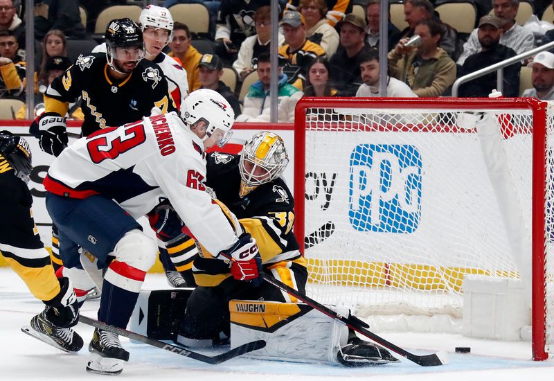 Mar 7, 2024; Pittsburgh, Pennsylvania, USA; Washington Capitals left wing Ivan Miroshnichenko (63) scores his first career NHL goal against Pittsburgh Penguins goaltender Alex Nedeljkovic (39) during the second period at PPG Paints Arena. Mandatory Credit: Charles LeClaire-USA TODAY Sports