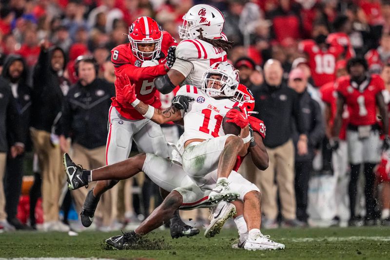 Nov 11, 2023; Athens, Georgia, USA; A Mississippi Rebels wide receiver Jordan Watkins (11) is tackled by Georgia Bulldogs linebacker C.J. Allen (33) during the second half at Sanford Stadium. Mandatory Credit: Dale Zanine-USA TODAY Sports