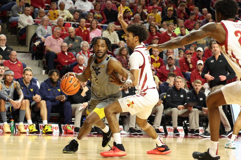 Feb 24, 2024; Ames, Iowa, USA; Iowa State Cyclones guard Curtis Jones (5) defends West Virginia Mountaineers guard Kobe Johnson (2) during the second half at James H. Hilton Coliseum. Mandatory Credit: Reese Strickland-USA TODAY Sports