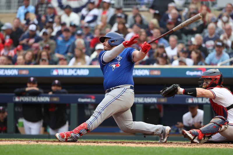 Oct 4, 2023; Minneapolis, Minnesota, USA; Toronto Blue Jays catcher Alejandro Kirk (30) hits a single in the sixth inning against the Minnesota Twins  during game two of the Wildcard series for the 2023 MLB playoffs at Target Field. Mandatory Credit: Jesse Johnson-USA TODAY Sports