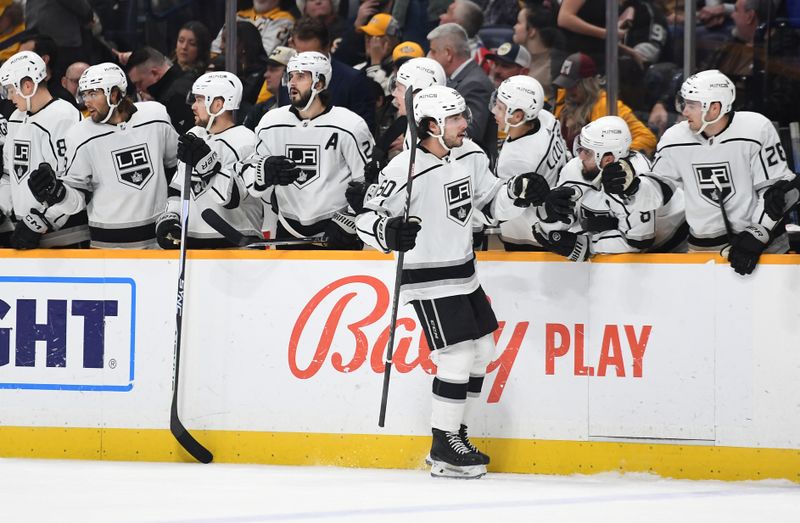 Jan 21, 2023; Nashville, Tennessee, USA; Los Angeles Kings defenseman Sean Durzi (50) celebrates with teammates after a goal during the first period against the Nashville Predators at Bridgestone Arena. Mandatory Credit: Christopher Hanewinckel-USA TODAY Sports