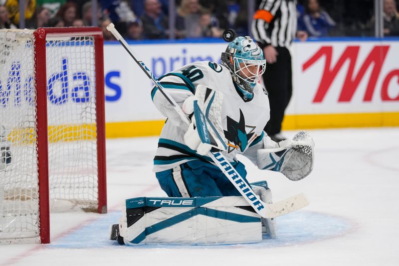 Mar 3, 2025; Toronto, Ontario, CAN; San Jose Sharks goaltender Alexandar Georgiev (40) makes a save with his helmet against the Toronto Maple Leafs during the period at Scotiabank Arena. Mandatory Credit: John E. Sokolowski-Imagn Images