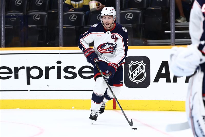 Oct 26, 2024; Nashville, Tennessee, USA; Columbus Blue Jackets defenseman Zach Werenski (8) takes the puck around the boards in the first period against the Nashville Predators at Bridgestone Arena. Mandatory Credit: Casey Gower-Imagn Images