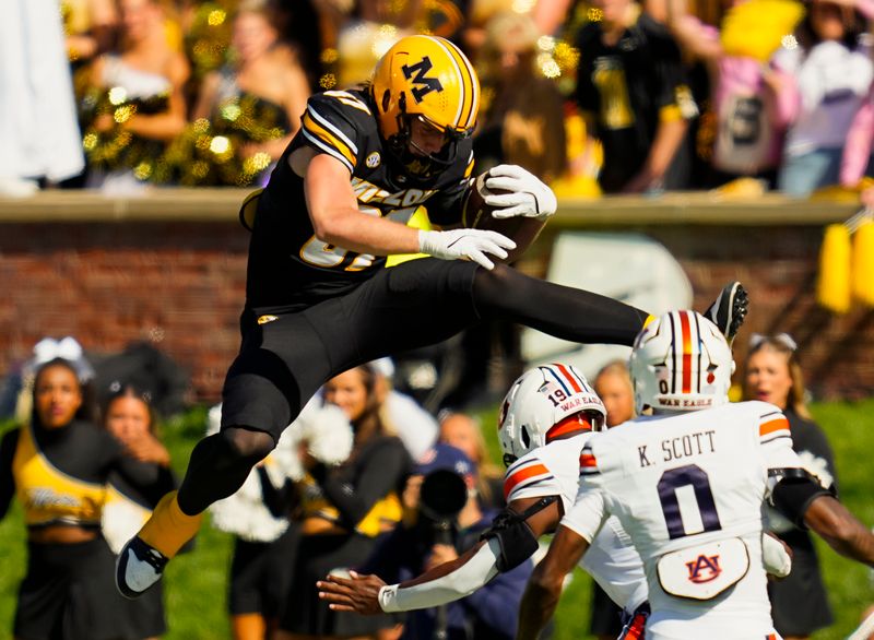 Oct 19, 2024; Columbia, Missouri, USA; Missouri Tigers tight end Brett Norfleet (87) hurdles Auburn Tigers safety Sylvester Smith (19) during the second half at Faurot Field at Memorial Stadium. Mandatory Credit: Jay Biggerstaff-Imagn Images