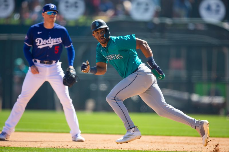 Mar 13, 2024; Phoenix, Arizona, USA; Seattle Mariners outfielder Julio Rodriguez against the Los Angeles Dodgers during a spring training game at Camelback Ranch-Glendale. Mandatory Credit: Mark J. Rebilas-USA TODAY Sports