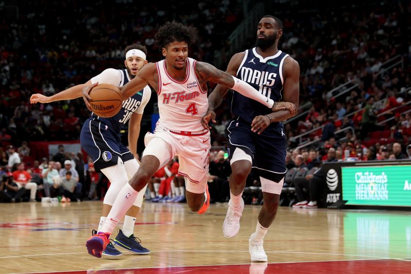 HOUSTON, TEXAS - DECEMBER 22: Jalen Green #4 of the Houston Rockets drives to the basket while defended by Tim Hardaway Jr. #10 of the Dallas Mavericks in the second half at Toyota Center on December 22, 2023 in Houston, Texas.   NOTE TO USER: User expressly acknowledges and agrees that, by downloading and or using this photograph, User is consenting to the terms and conditions of the Getty Images License Agreement. (Photo by Tim Warner/Getty Images)