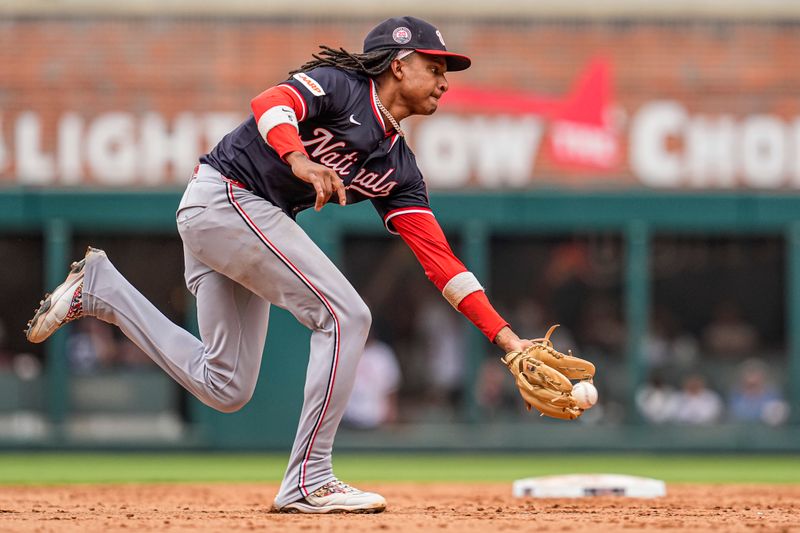 Sep 24, 2025; Cumberland, Georgia, USA; Washington Nationals shortstop CJ Abrams (5) fields a ball hit by Atlanta Braves right fielder Ronald Acuna Jr (13) (not shown) during the ninth inning at Truist Park. Mandatory Credit: Dale Zanine-Imagn Images