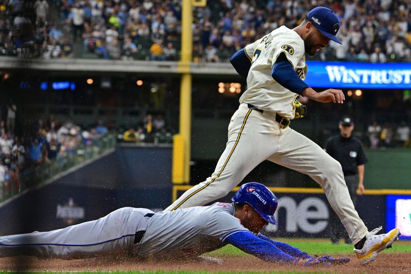 Oct 1, 2024; Milwaukee, Wisconsin, USA; New York Mets second base Jose Iglesias (11) slides safely for a hit against Milwaukee Brewers pitcher Joel Payamps (31) during the fifth inning in game one of the Wildcard round for the 2024 MLB Playoffs at American Family Field. Mandatory Credit: Benny Sieu-Imagn Images