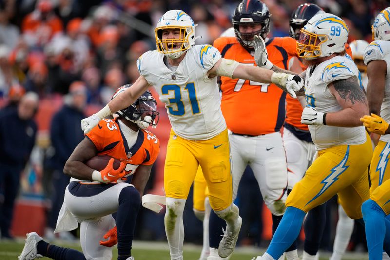 Los Angeles Chargers linebacker Nick Niemann (31) reacts adfter stopping Denver Broncos running back Javonte Williams (33) in the second half of an NFL football game in Empower Field at Mile High Sunday, Dec. 31, 2023, in Denver. (AP Photo/David Zalubowski)